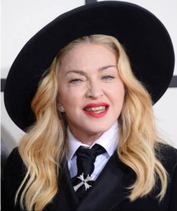 Madonna attends Grammys dressed as a witch wearing a Knights Templar (Illuminati) cross pinned to her tie. 1-26-2014