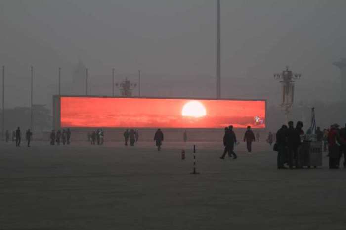 China - Smog in Beijing Is So Awful You Have to Catch the Sunrise on a Big Screen! In the airpocalypse, fake sunrises are a thing. This LED screen displays the rising sun in Beijing's Tiananmen Square, which is shrouded in heavy smog on Jan. 16, 2014. Air pollution in the Chinese capital reached new, choking heights on Thursday. Those who still felt the urge to catch a glimpse of sunlight were able to gather around the city’s gigantic LED screens, where this glorious sunrise was broadcast as part of a patriotic video loop. Read more: Beijing's Televised Sunrise | TIME.com http://world.time.com/2014/01/17/beijing-smog-combatted-with-televised-sunrises/#ixzz2qgmzJplW