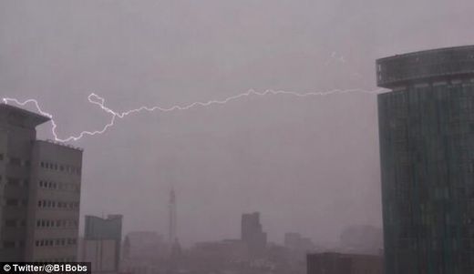 Lightning strikes: This dramatic picture shows the moment a bolt of lightning struck a building in Birmingham as fierce storms battered Britain. 1-25-2014