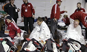 Runners cover themselves with foil blankets as they receive medical attention in the medical tent after running in the Boston Marathon on April 16, 2007.